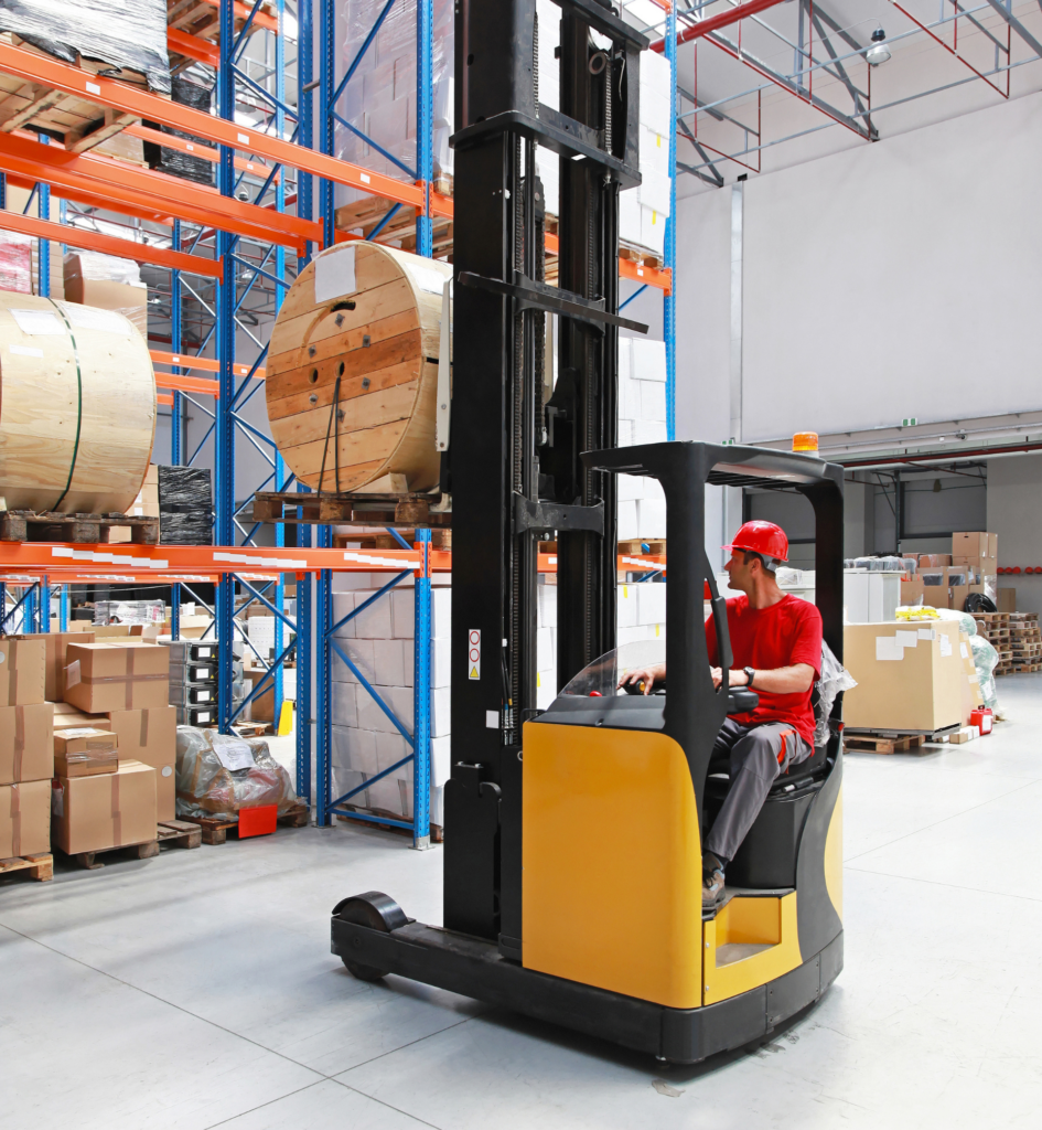 APF staff member on a reach truck in a cold storage warehouse
